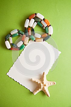 Green postcard with beads and shells