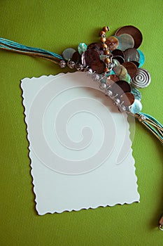 Green postcard with beads and shells