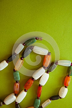 Green postcard with beads and shells