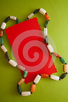 Green postcard with beads and shells