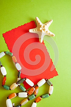 Green postcard with beads and shells