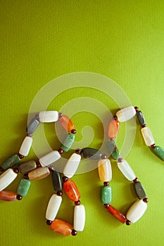 Green postcard with beads and shells