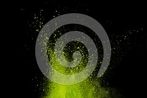 Green powder explosion isolated on Black background.Colored dust splash isolated