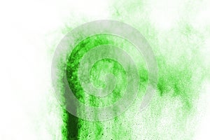 Green powder explosion on white background.