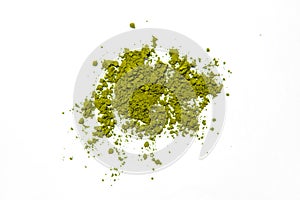 Green powder of Japanese matcha tea on a platter, isolated on a white background.