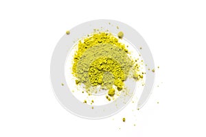 Green powder of Japanese matcha tea on a platter, isolated on a white background. Loose powder. Space for text. Cafe and cooking,