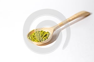 Green powder of Japanese matcha tea in a teaspoon.