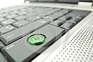 Green power button on front panel of computer or laptop