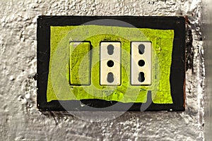 Green power Outlet in silver color wall