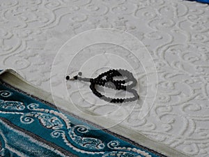 Green prayer rug and rosary. green prayer rug and ramadan month