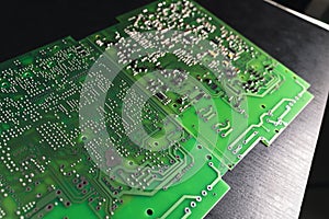 Green Printed Circuit Board (PCB) with some Surface Mount Device (SMD) components and chips
