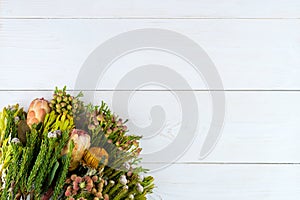 Green proteus bouquet on wooden background with copyspace for yo