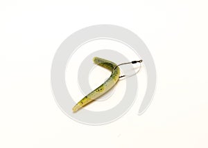 Green pumpkin plastic worm hooked in weedless bait holder hook isolated on white