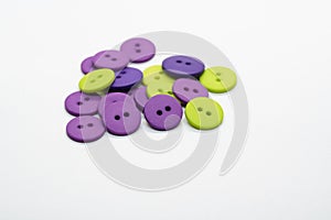 Green and purple buttons in a pile