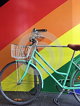 Green Pushbike and Rainbow Wall