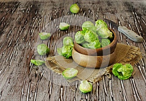 Green raw Brussels sprouts in wooden bowl , selective focus