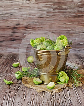 Green raw Brussels sprouts in wooden bowl , selective focus