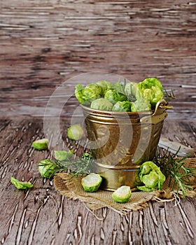 Green raw Brussels sprouts in wooden bowl , selective focus