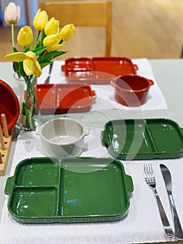 Green ceramic plates on a table in a restaurant. Selective focus.