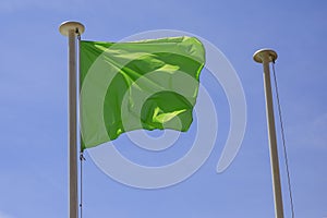 A green rectangular flag on a pole