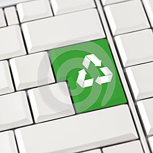 Green recycle icon on a computer keyboard