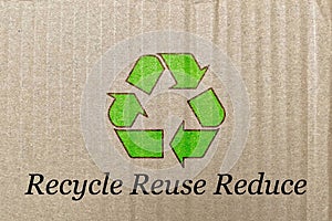 Green recycling arrow icon on waste packaging paper, recycle reuse and reduce to protect environment