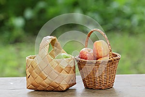 Green and red apples in a basket