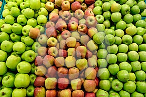 Green and red apples on the store counter top view.