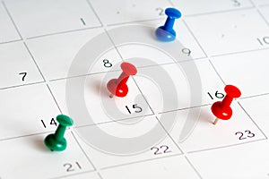 Green red blue pins on calendar