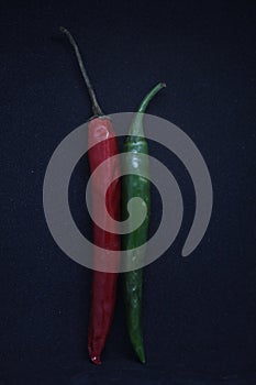 Green and Red chili potrait on a background black