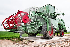 Green and red combine harvester, Latvia