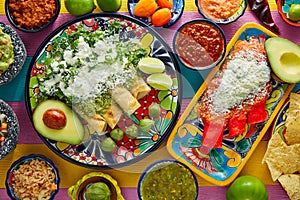 Green and red enchiladas with mexican sauces