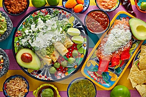 Green and red enchiladas with mexican sauces photo