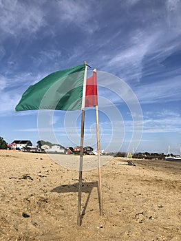 Green and red flags at beach