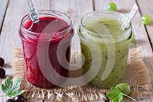 Green and red gooseberry jam in jars