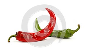 Green and red hot chili peppers close up on white