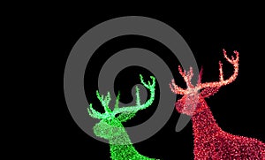 Green and Red Illuminated Christmas Reindeer Shaped Outdoor Decoration Lights on Night Sky Background