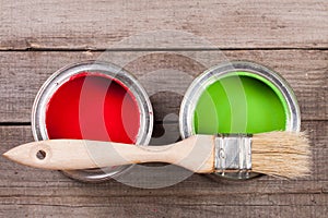 green and red paint in the bank to repair and brush on the old wooden background