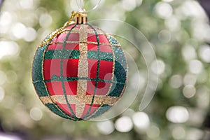 Green and red pattern Christmas decoration globe with soft creamy bokeh background