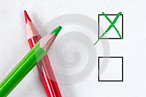 Green and red pencils with marking checkbox