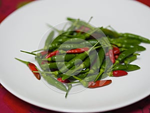 Green red Thai pepper, Chilli Padi, Capsicum annuum freshness on white plate vegetable food