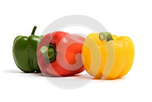 Green, red, yellow sweet bell peppers isolated on white background