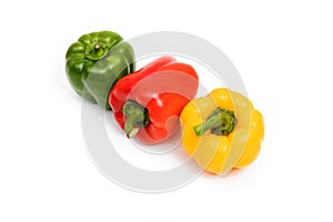 Green, red, yellow sweet bell peppers isolated on white background
