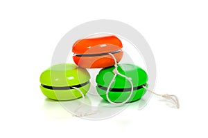 Green and red yoyos on a white background