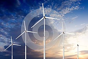 Green renewable energy concept - wind generator turbines in sky