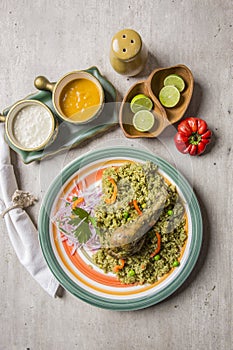 Green rice with chicken leg and onion sauce arroz con pollo y zarza de cebolla Peruvian comfort food buffet traditional table photo