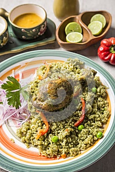 Green rice with chicken leg and onion sauce arroz con pollo y zarza de cebolla Peruvian comfort food buffet traditional table photo