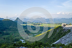 The green rice fields in the middle of the mountains in the valley, Asia, Vietnam, Tonkin, towards Hanoi, Mai Chau, in summer, on