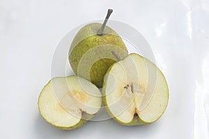 The green ripe sliced pear isolated on white background