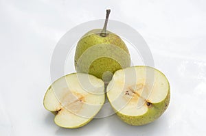 The green ripe sliced pear isolated on white background